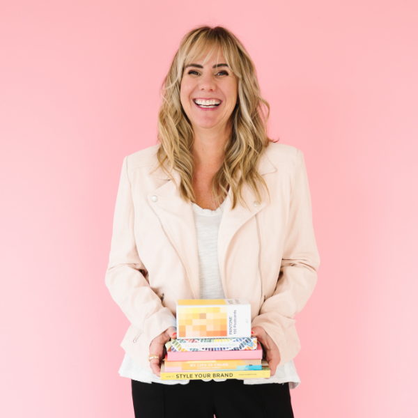 Cindy Albanese Brand Designer holding design books smiling