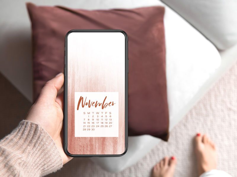 Woman holding phone backgrounds for November
